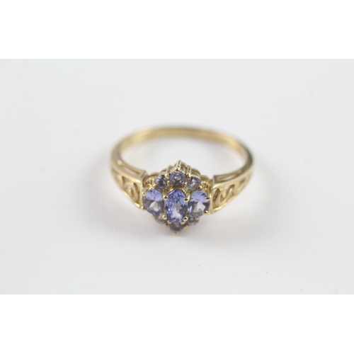 37 - 9ct gold tanzanite cluster dress ring w/ cut work shoulders (2.5g) Size P