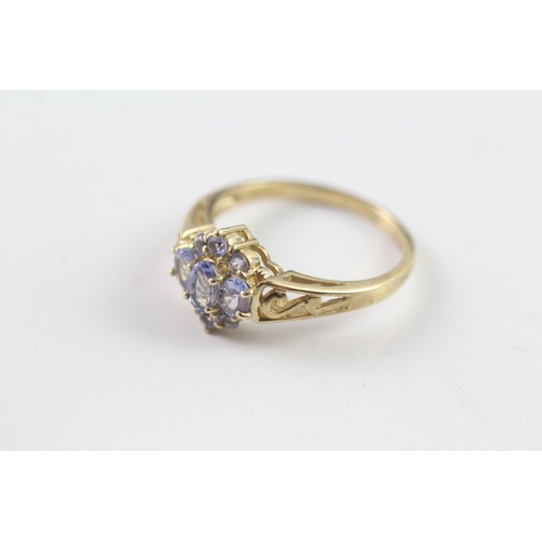 37 - 9ct gold tanzanite cluster dress ring w/ cut work shoulders (2.5g) Size P