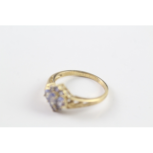 37 - 9ct gold tanzanite cluster dress ring w/ cut work shoulders (2.5g) Size P