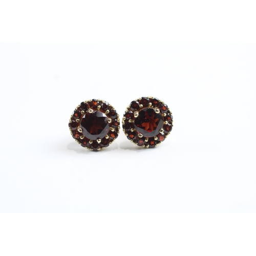 24 - 9ct gold garnet halo stud earrings (2g)