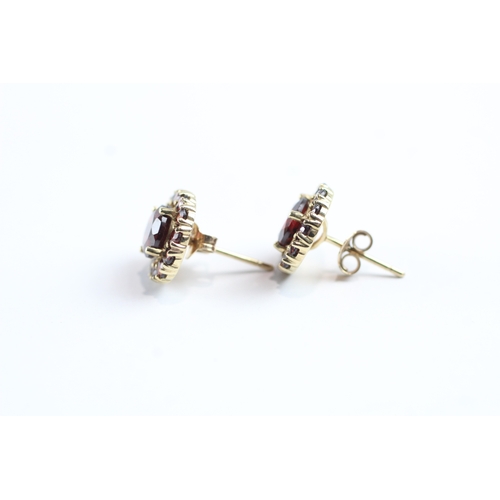 24 - 9ct gold garnet halo stud earrings (2g)