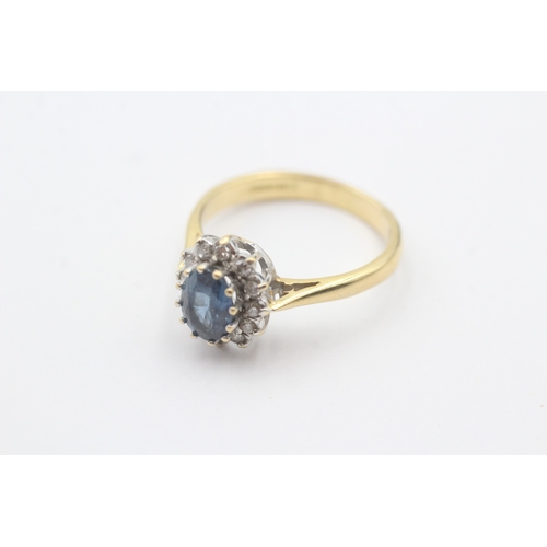 68 - 18ct gold blue gemstone and diamond halo set ring (3.9g) Size N