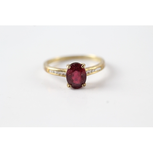 61 - 9ct gold oval cut red gemstone & diamond dress ring (1.7g) Size N