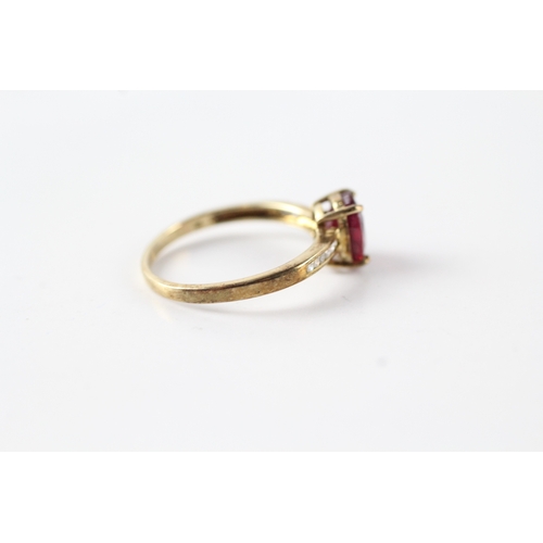 61 - 9ct gold oval cut red gemstone & diamond dress ring (1.7g) Size N