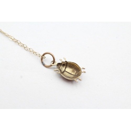 64 - 9ct gold enamel lady bug pendant on chain (1g)