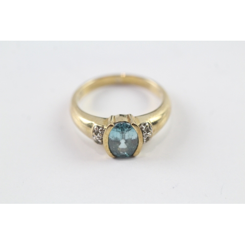 69 - 9ct gold oval cut blue gemstone dress ring w/ why gemstone set shoulders (3.5g) Size N