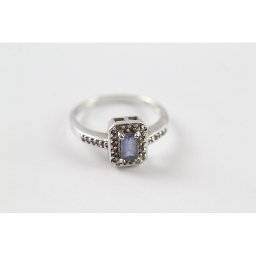 73 - 9ct white gold blue gemstone and diamond halo dress ring w/ diamond set shoulders (2.1g) Size L