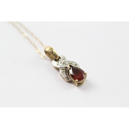 44 - 9ct gold diamond and red gemstone twist pendant on chain (1.5g)