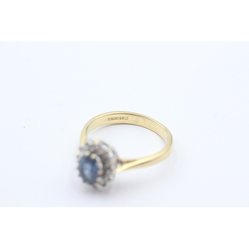 68 - 18ct gold blue gemstone and diamond halo set ring (3.9g) Size N