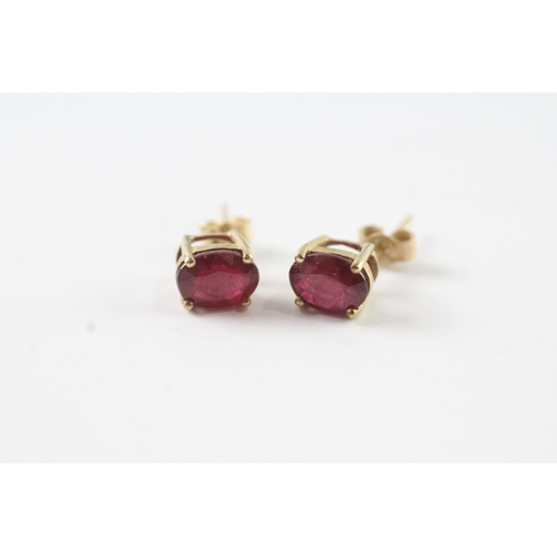 76 - 9ct gold oval cut ruby stud earrings (1.3g)