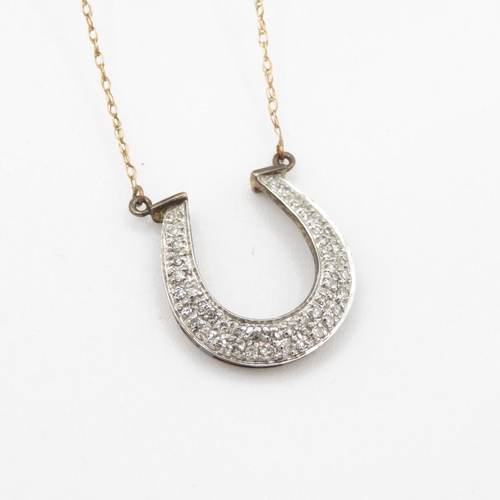 129 - 9ct gold diamond set horse shoe pendant necklace (1.9g)