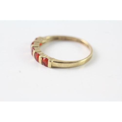 51 - 9ct gold orange gemstone half eternity ring (2.3g) Size U