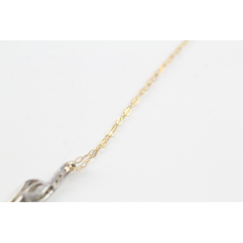 109 - 9ct gold diamond double twist pendant on chain (1g)