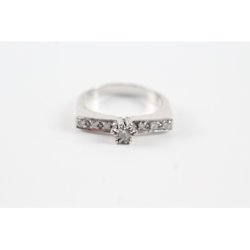 129 - 18ct white gold diamond solitaire w/ diamond set squared shoulder dress ring (5.8g) Size U