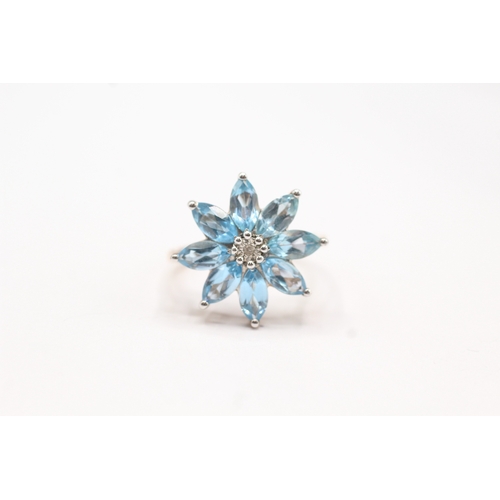 241 - 9ct gold diamond & blue gemstone flower ring (3.1g) Size P