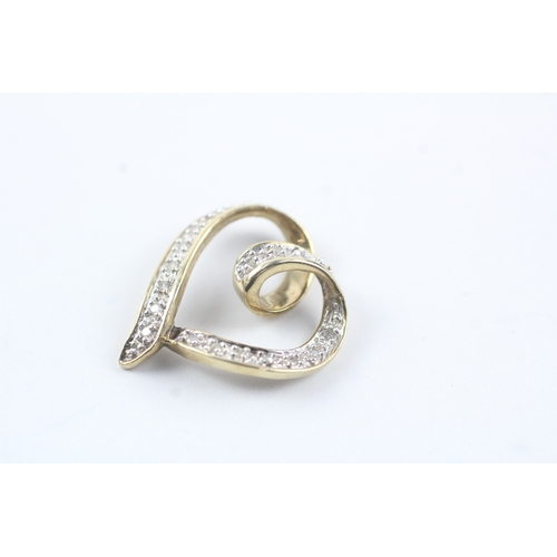 87 - 9ct gold diamond love heart pendant (2.2g)