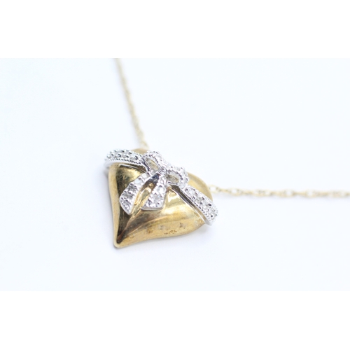 26 - 9ct gold diamond heart shape bow pendant necklace (2.6g)