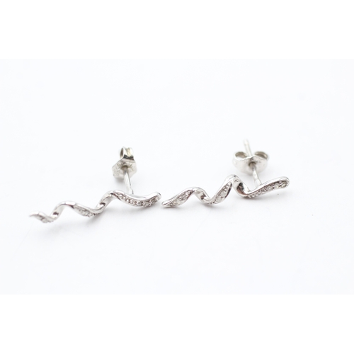 128 - 9ct white gold twisted diamond stud earrings (1.1g)