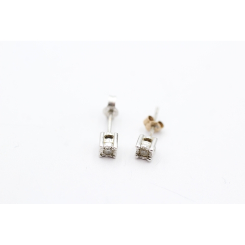 206 - 9ct gold x2 diamond stud earrings set (1.3g)