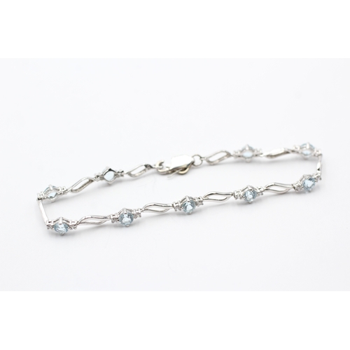 54 - 9ct gold diamond and topaz bracelet (5g)