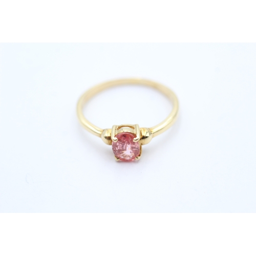 144 - 18ct gold oval cut enhanced padparadscha sapphire solitaire ring (2.1g) Size O