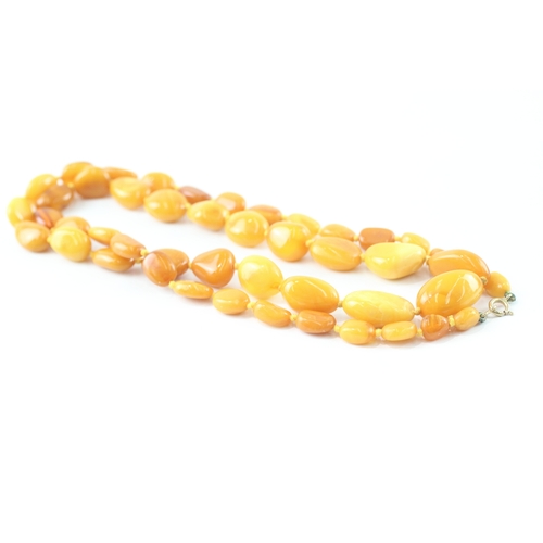 191 - 9ct gold clasped amber necklace (39g)