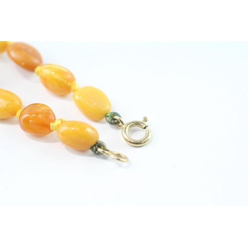 191 - 9ct gold clasped amber necklace (39g)