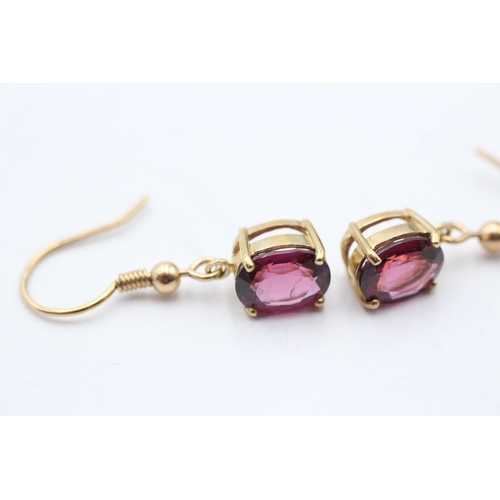 97 - 9ct gold oval cut purple garnet drop earrings with French hooks (2.9g)