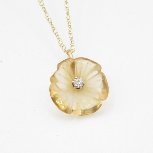 181 - 9ct gold citrine and diamond carved flower pendant on chain (2g)