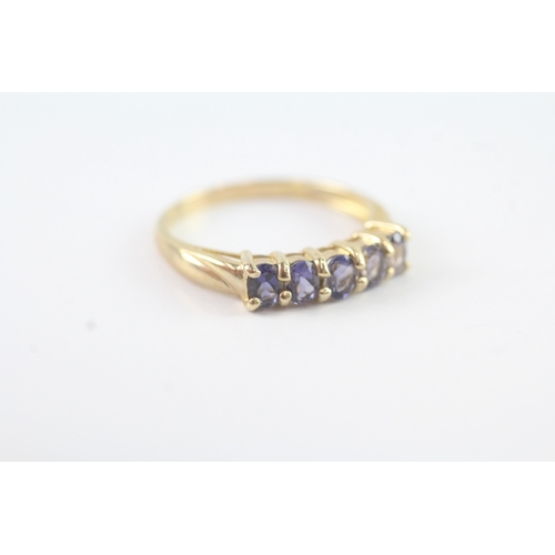 103 - 9ct gold purple gemstone row ring (1.9g) Size R