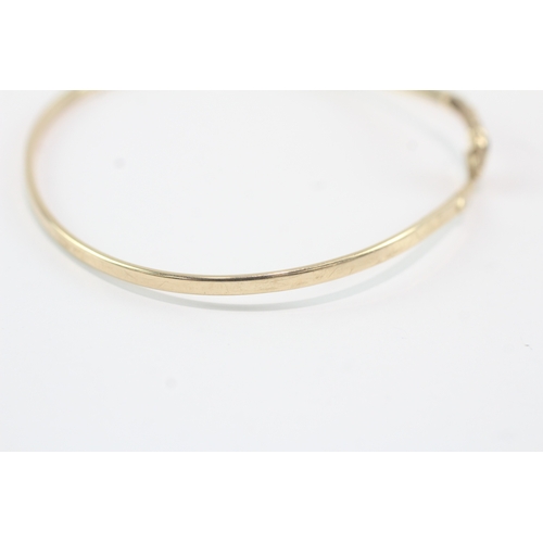 140 - 9ct gold garnet eyed snake bangle (4.9g)