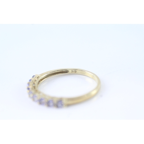 144 - 9ct gold tanzanite row ring (1.4g) Size P