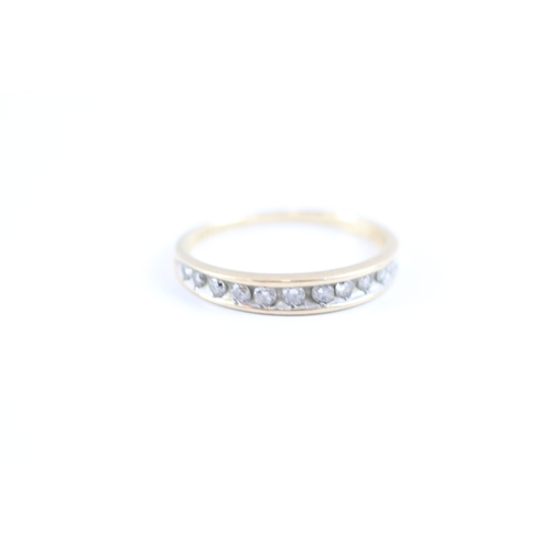 21 - 9ct gold diamond channel set eternity band (1.4g) Size M