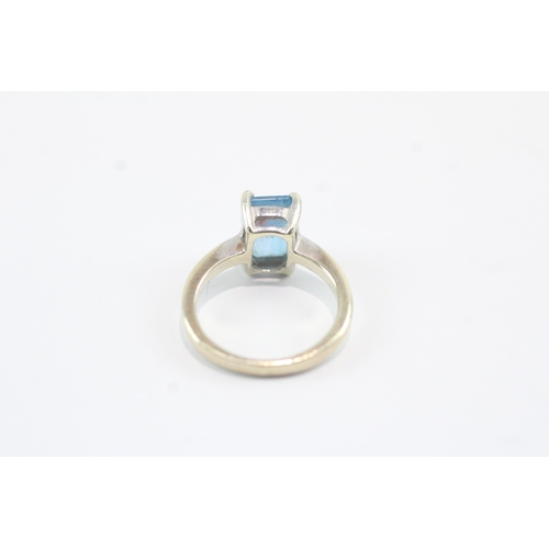 159 - 9ct gold emerald cut blue topaz dress ring (2.5g) Size F