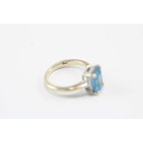 159 - 9ct gold emerald cut blue topaz dress ring (2.5g) Size F