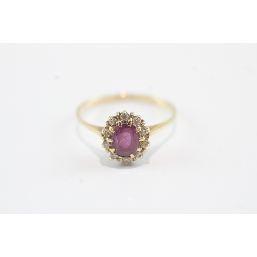 44 - 18ct gold ruby & diamond halo dress ring (2.1g) Size P