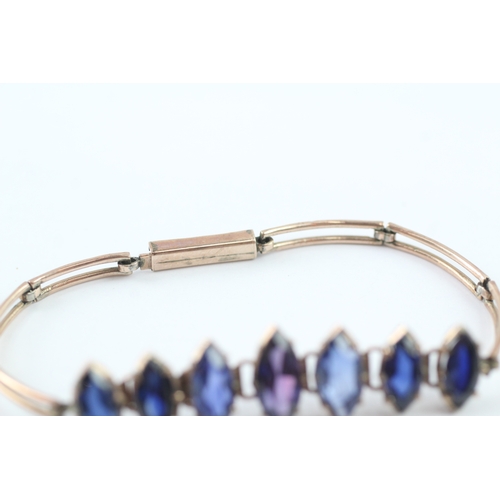 63 - 9ct gold vari-hue sapphire bracelet (6.5g)