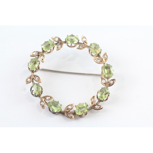 86 - 9ct gold vintage peridot and diamond halo brooch (6.8g)