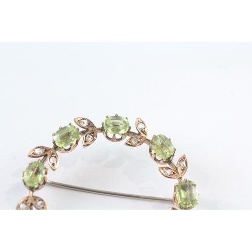 86 - 9ct gold vintage peridot and diamond halo brooch (6.8g)