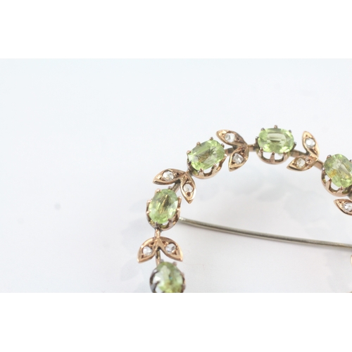 86 - 9ct gold vintage peridot and diamond halo brooch (6.8g)