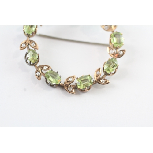 86 - 9ct gold vintage peridot and diamond halo brooch (6.8g)