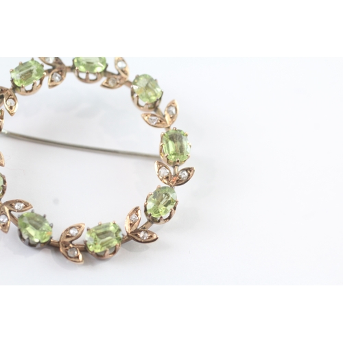 86 - 9ct gold vintage peridot and diamond halo brooch (6.8g)