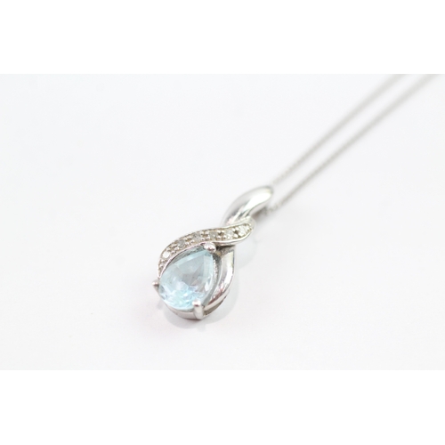 92 - 9ct white gold diamond and blue gemstone twist pendant on chain (2g)