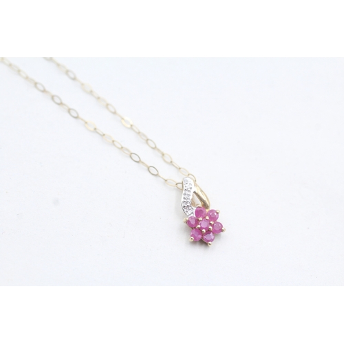 101 - 9ct gold diamond and ruby set floral pendant and chain (1g)