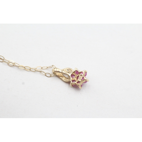 101 - 9ct gold diamond and ruby set floral pendant and chain (1g)