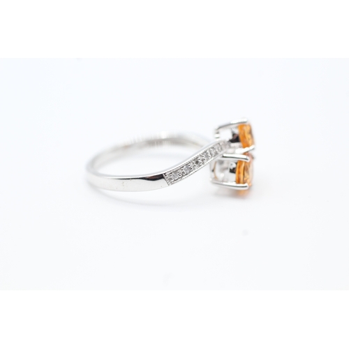 142 - 9ct white gold diamond and orange diopside set bypass ring (2.5g) Size N