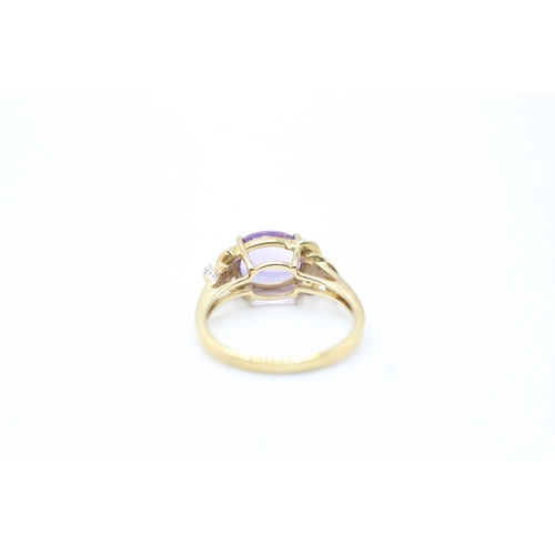 143 - 9ct gold diamond accented amethyst set cocktail ring (3.1g) Size N