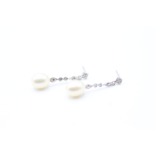 144 - 9ct gold diamond and pearl drop earrings (2.2g)