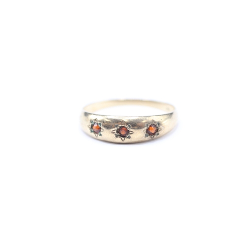 176 - 9ct gold garnet three stone ring (1.2g) Size L