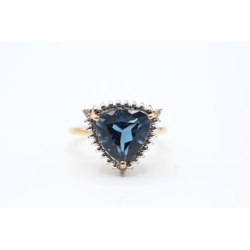 73 - 9ct gold diamond and blue gemstone halo ring (3.8g) Size O